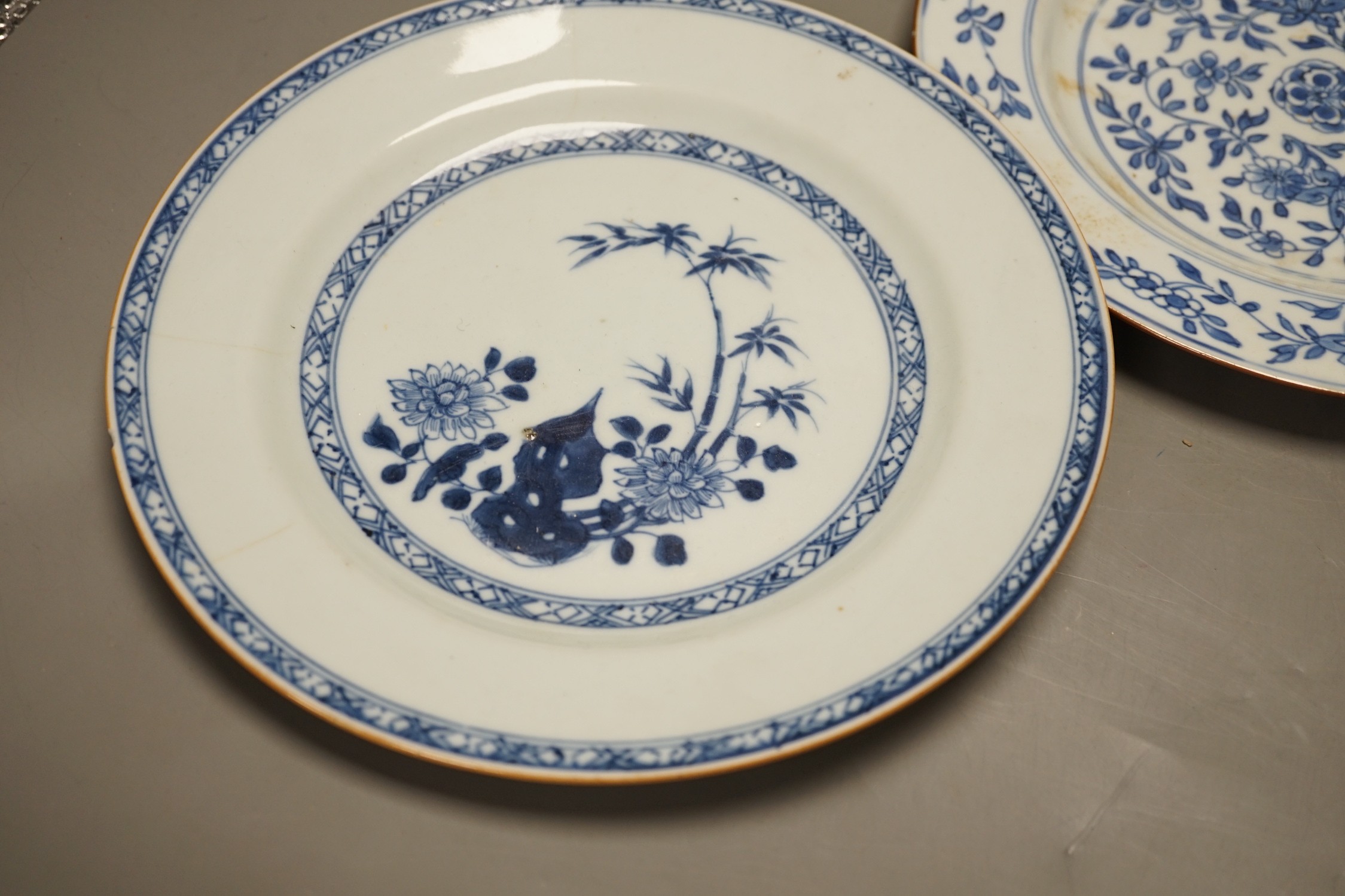 Four Chinese 18th century plates and a late 19th century blue and white dragon plate, largest 24cm diameter